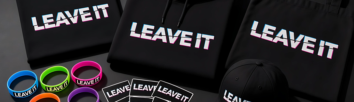 Black merch laid out on a dark table under neon light.