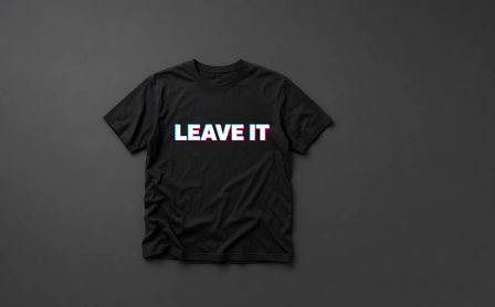 A black t-shirt with a white sliced LEAVE IT print, flat on a dark background.